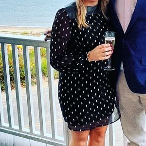 Black and gold cocktail dress with open back, sheer sleeves and leather accent